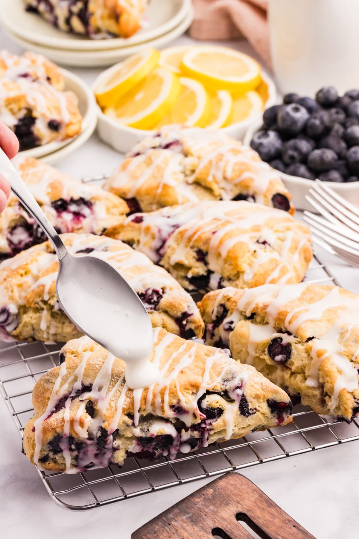 Drizzling scones with lemon glaze.