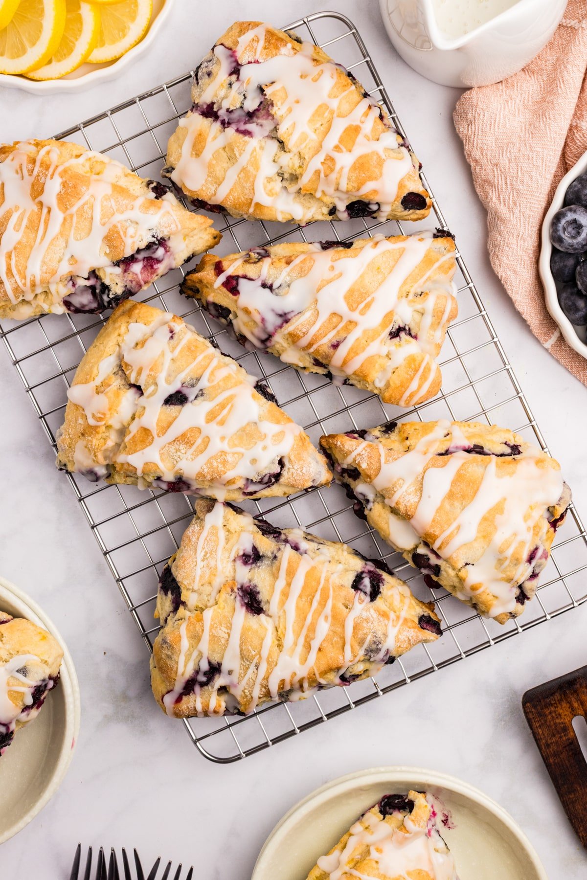 Blueberry scones on a wire baking rack.