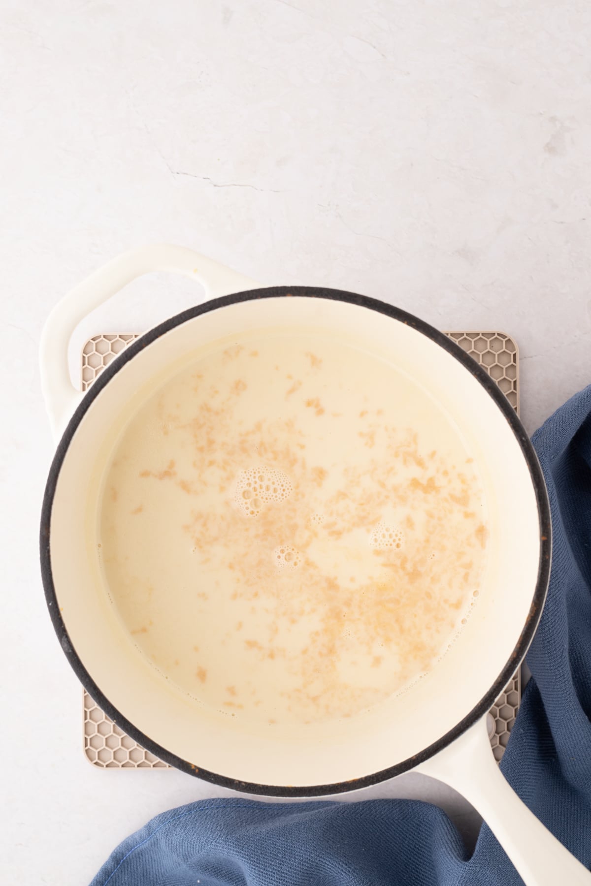 A small saucepan filled with homemade creamer, with a bit of vanilla extract added.