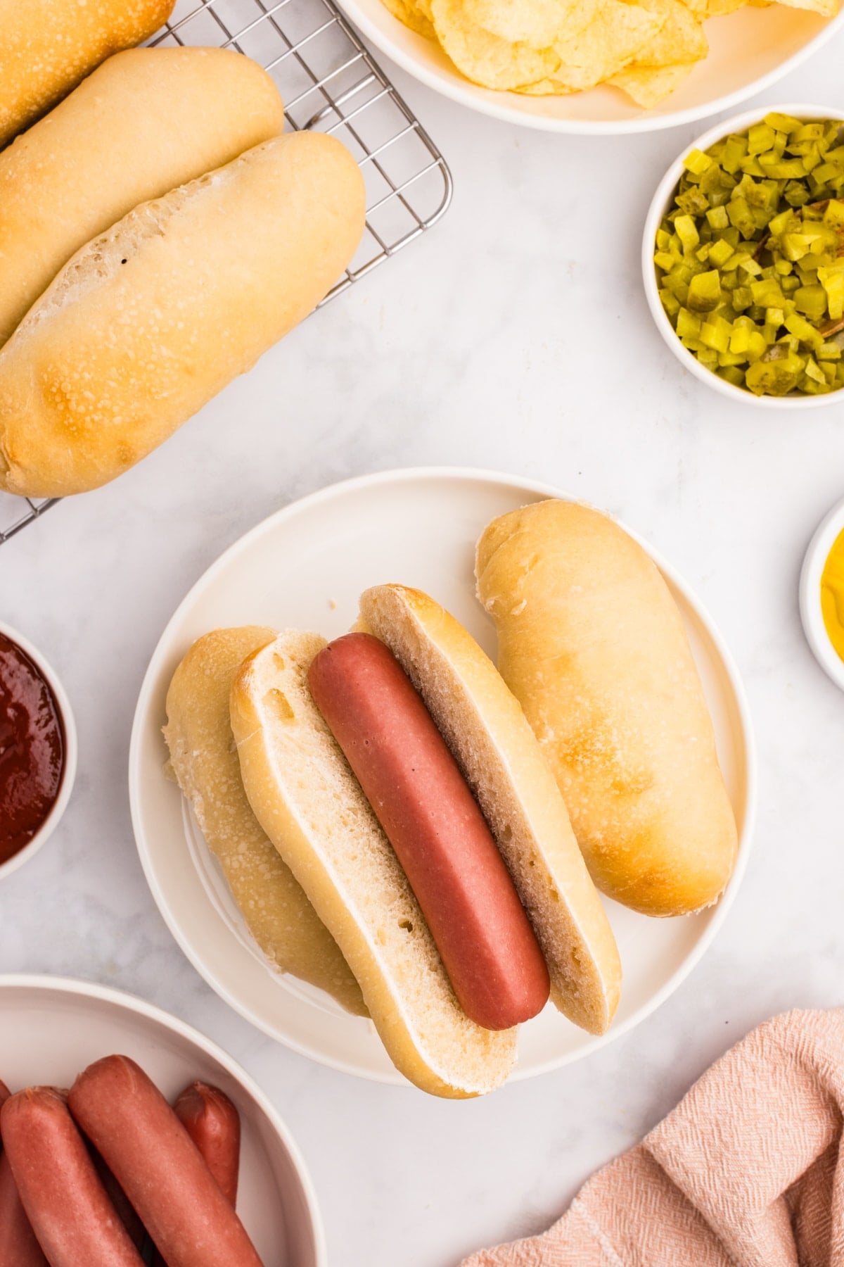 A sourdough hot dog roll with a cooked hot dog in the middle.