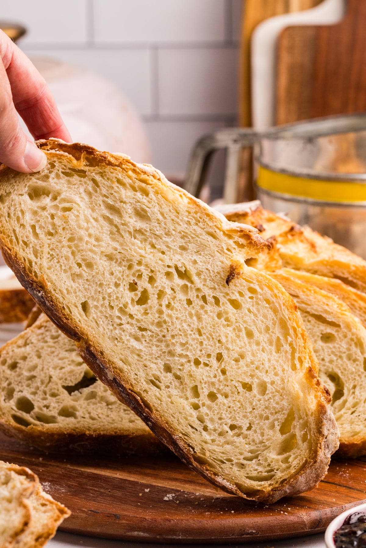 Taking a slice of sourdough bread from a sliced loaf.