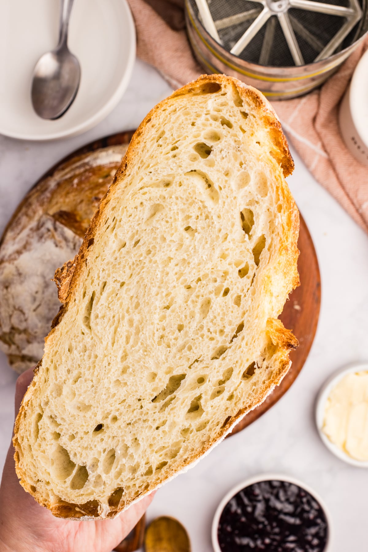 A loaf of sourdough bread sliced in half, showing the crumb and texture.