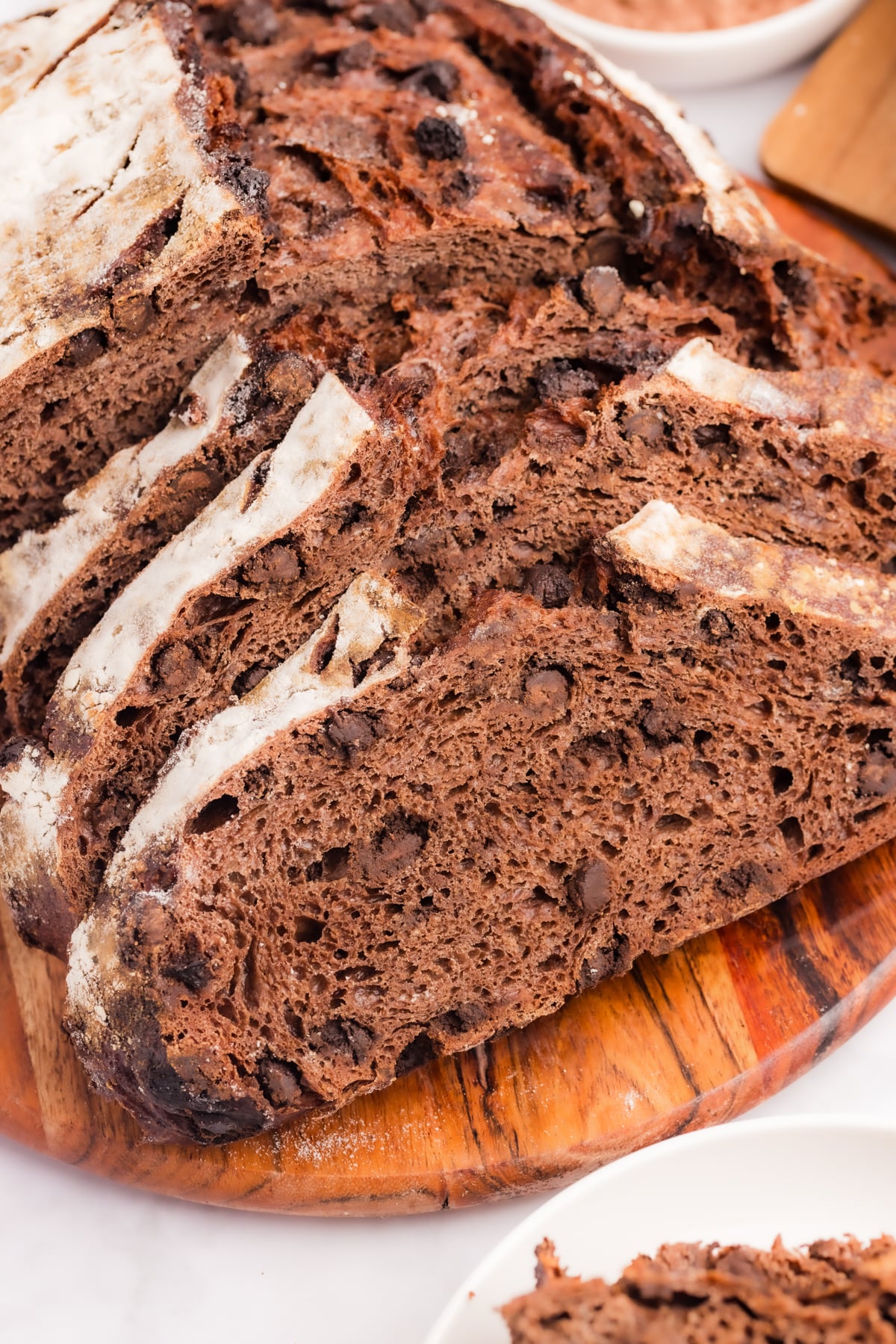 Slices of double chocolate sourdough bread layered on a cutting board.