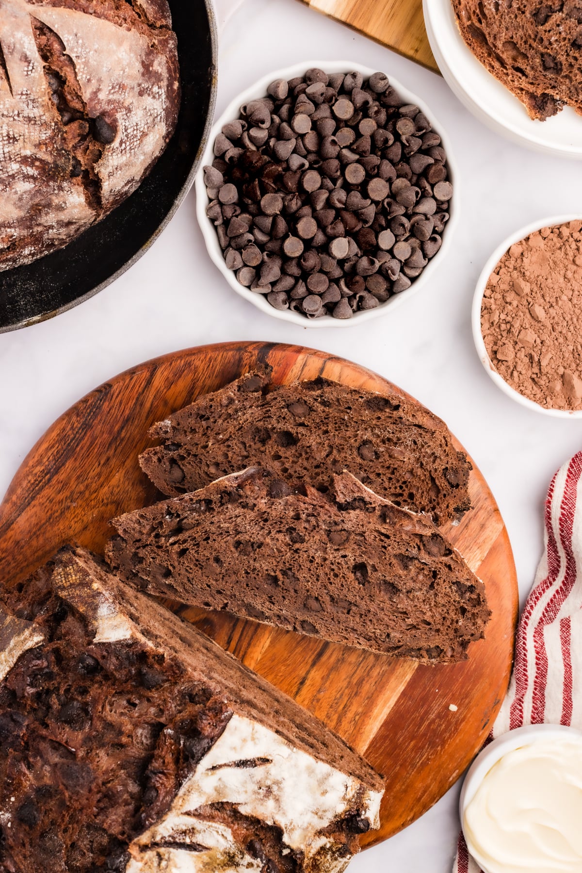 Slices of double chocolate sourdough bread on a round cutting board.