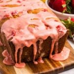 A loaf of sourdough bread with strawberry glaze dripping down the sides.
