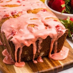 A loaf of sourdough bread with strawberry glaze dripping down the sides.